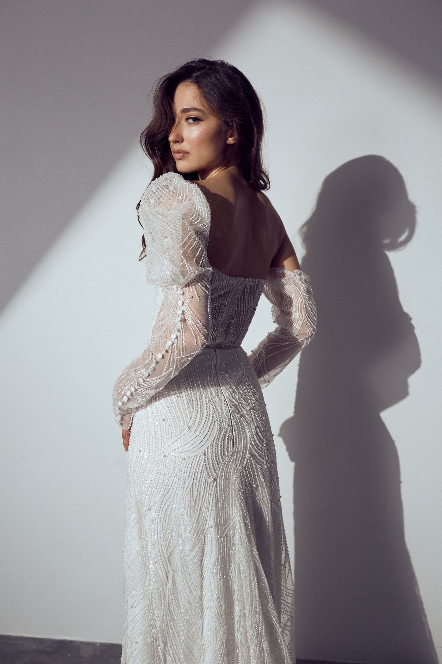 Sophisticated lace wedding dress highlighting ornate lace patterns and a graceful train