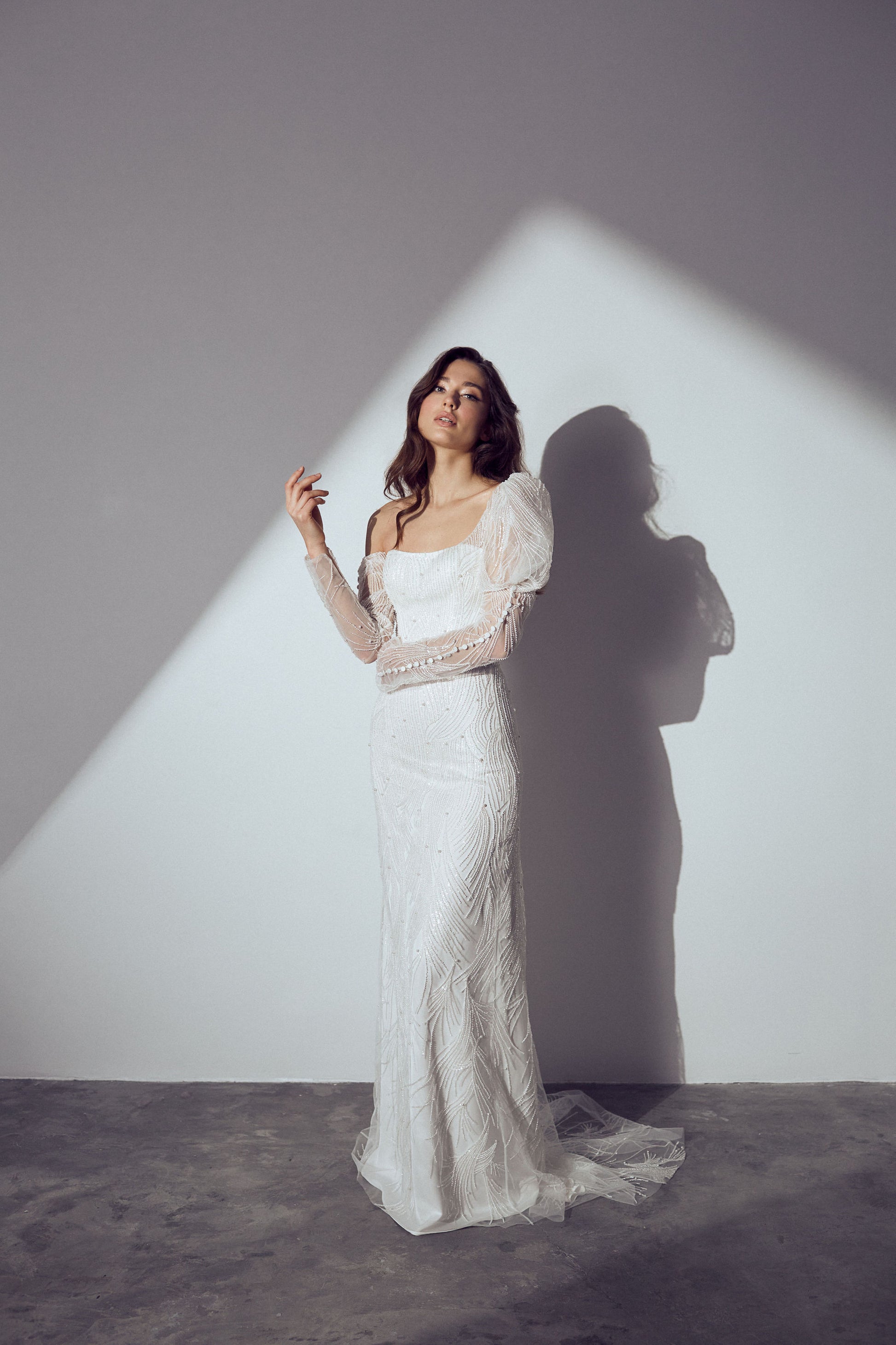 Off-the-shoulder lace wedding gown with structured corset and flowing train