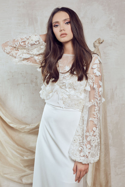 Ivory lace bridal dress with sheer long sleeve cover-up and slim bias-cut skirt with train.